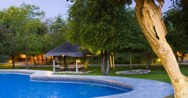 Mushara Lodge swimming pool and thatched chalets