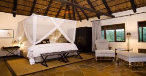 Mosquito-netted bedroom in a Mushara Lodge chalet
