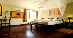 Air-conditioned chalet bedroom at Etosha Safari Camp