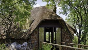 Stone-and-thatch exterior of a Little Ongava villa