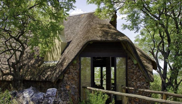 Stone-and-thatch exterior of a Little Ongava villa
