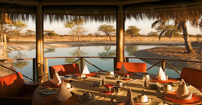 Breakfast tables at Onguma Bush Camp beside the waterhole