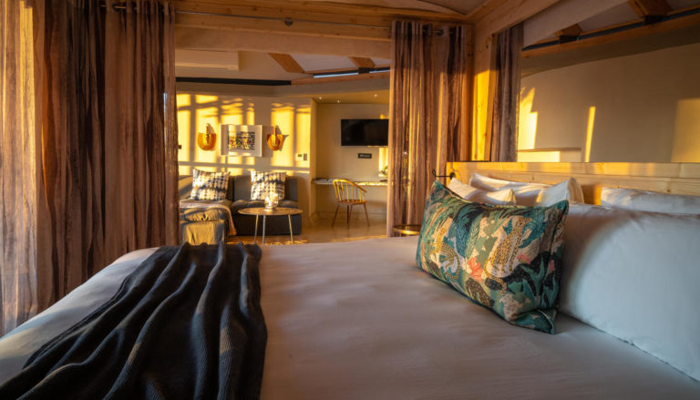 Bedroom and lounge in Anderssons at Ongava accommodation