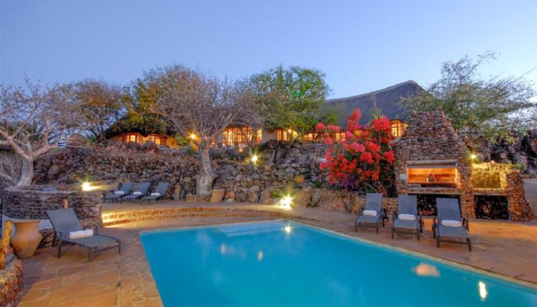 Okutala accommodation – swimming pool and thatched lodge buildings