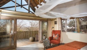Mosquito-netted chalet bedroom at Ongava Lodge