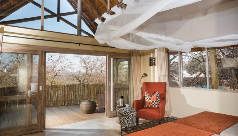 Mosquito-netted chalet bedroom at Ongava Lodge