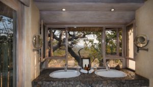 Double vanity with bush view in Ongava Lodge accommodation
