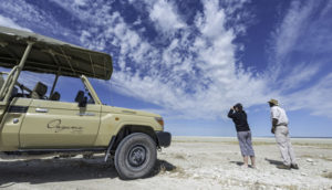 Onguma safari vehicle beside Etosha Pan