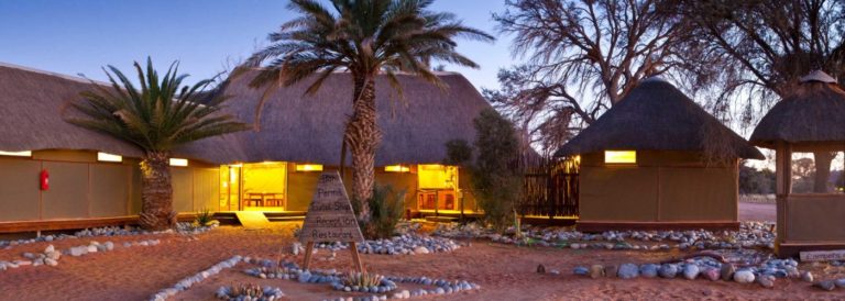 camping inside Namib-Naukluft Park – campsite entrance and thatched buildings