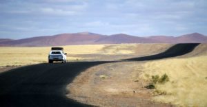 Sossusvlei camping – vehicle travelling through the dune landscape
