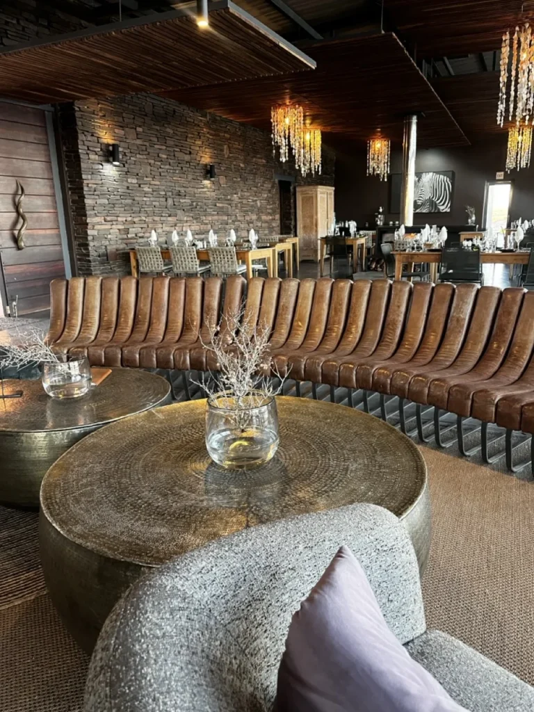 Curved lounge seating and stone tables at Fish River Lodge