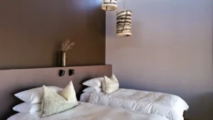 Pillows and bedside table in a Fish River Lodge chalet