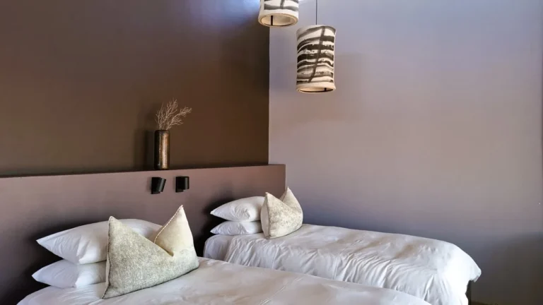 Pillows and bedside table in a Fish River Lodge chalet