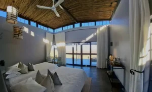 Spacious chalet bedroom with roof windows at Fish River Lodge