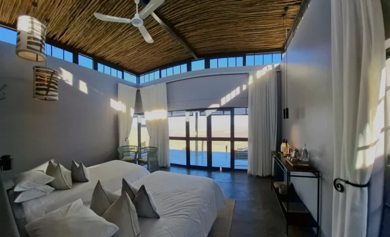 Spacious chalet bedroom with roof windows at Fish River Lodge