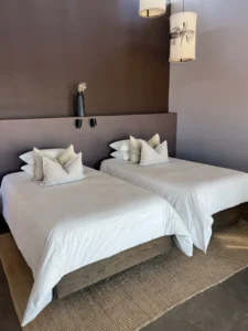 Twin beds inside a Fish River Lodge chalet