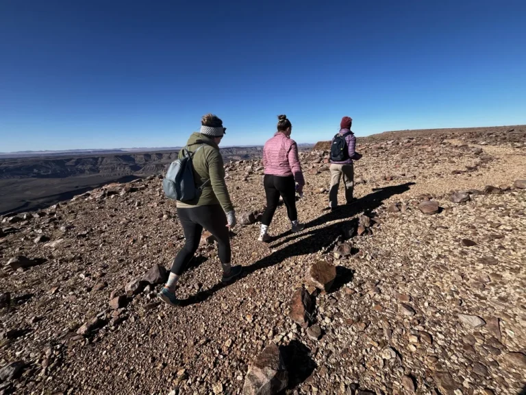 Guests hiking on a rocky canyon trail