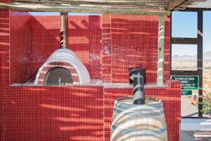At Kronenhof Lodge – red outdoor pizza oven beside the deck