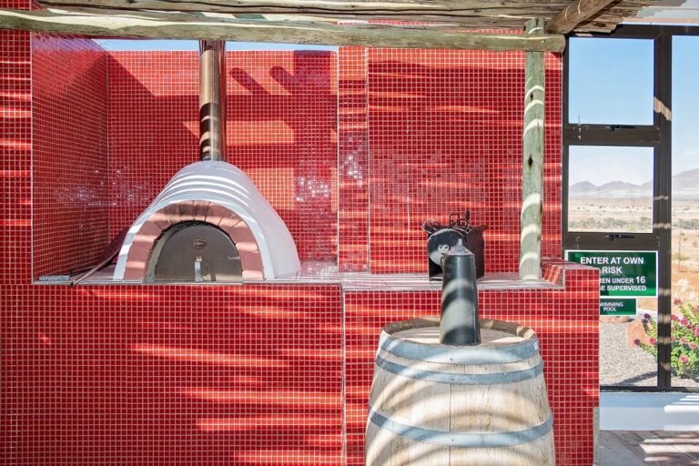 At Kronenhof Lodge – red outdoor pizza oven beside the deck