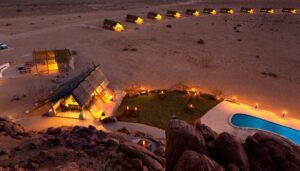 Sossusvlei camp – aerial view of pool and chalets at dusk