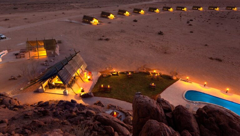 Sossusvlei camp – aerial view of pool and chalets at dusk