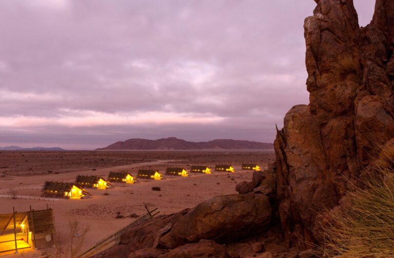 Sesriem self-catering accommodation – illuminated chalets viewed from the rocks