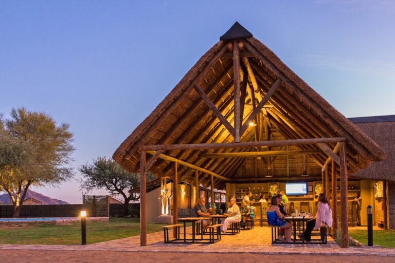 Desert Camp Sesriem – open-sided bar with evening guests