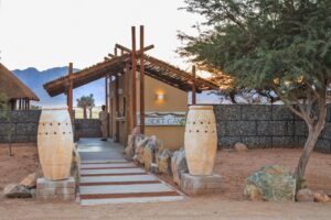 Desert Camp Sesriem – camp reception entrance beneath mature trees