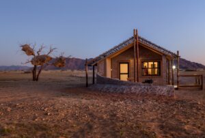 Sesriem desert camp – illuminated chalet beneath a camel-thorn tree
