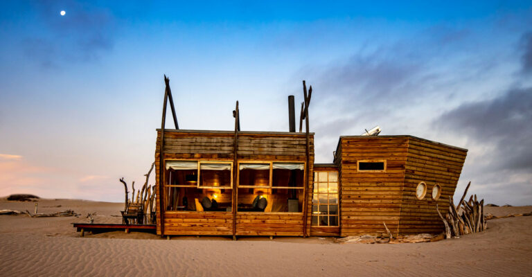 Skeleton Coast lodge – main lodge glowing in the desert dusk