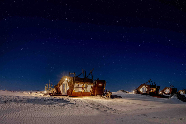 Shipwreck Lodge Namibia – lodge and cabins beneath a starry sky