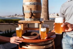 Strand Hotel accommodation – friends tasting beer on the sea-facing terrace