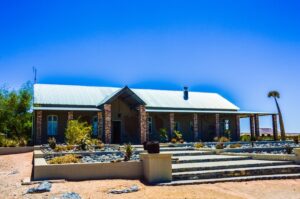 Alte Kalkofen Lodge – main lodge building beneath a deep blue sky