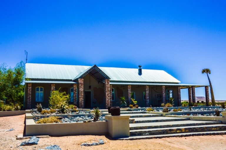 Alte Kalkofen Lodge – main lodge building beneath a deep blue sky