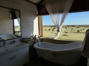 Bagatelle Kalahari – private bath overlooking Kalahari grassland
