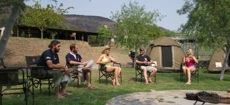 Vioolsdrift accommodation – camp guests relaxing around an outdoor fire