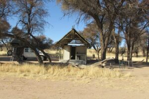 Kalahari Game Lodge – shaded campsite beside the dry Auob River