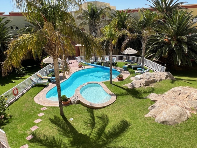 Namibia hotels: heated pool and landscaped garden at Lüderitz Nest Hotel