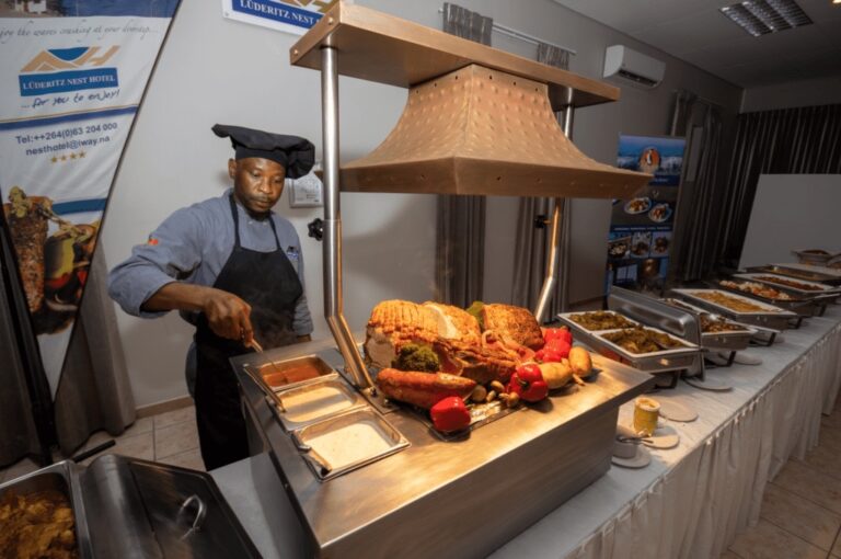 Lüderitz seafront hotel – chef serving a seafood buffet