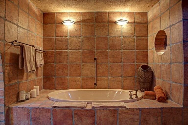Mount Etjo accommodation – bathtub and shower in an earth-toned bathroom