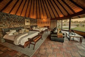 Mount Etjo Safari Lodge – villa bedroom and lounge with water views