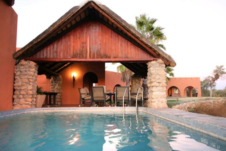 Mount Etjo Safari Lodge – pool and timber chalet exterior