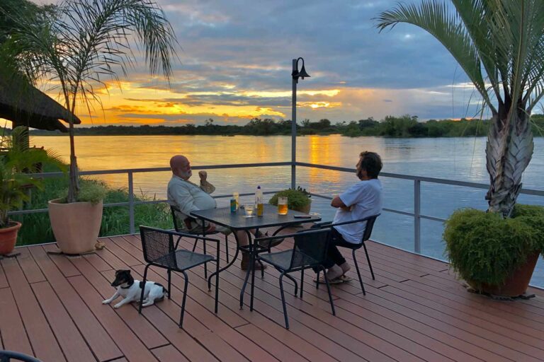 Kavango East lodge – guests dining on the sunset river deck