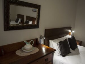 Lüderitz guesthouse – tea tray beside a guest bed