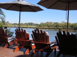 Divundu river lodge – wooden loungers overlooking the Kavango River