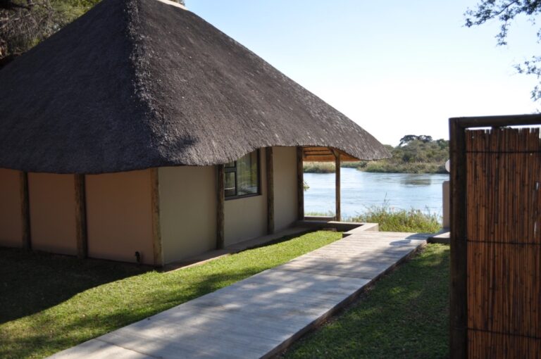 Kavango River lodge – thatched riverside chalet and garden path
