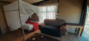 Spitzkoppe Tented Camp – tent lounge with armchair and bed