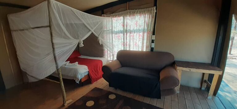 Spitzkoppe Tented Camp – tent lounge with armchair and bed
