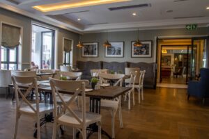 The Weinberg Hotel – restaurant seating and framed artwork