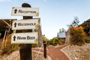UrbanCamp Windhoek – wooden signposts to reception and bar